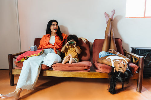 Playful Latin family enjoying quality time together on a cozy sofa