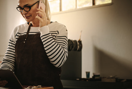 Jeweler discussing designs with client over phone