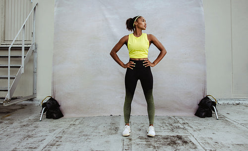 African sportswoman looking away after workout