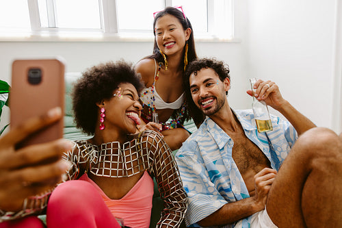 Friends celebrating in living room before Brazilian carnival