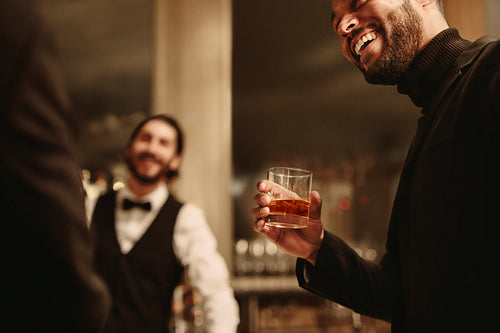 Man with a drink at party