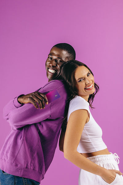 Generation Z credit card holders smile happily in a studio