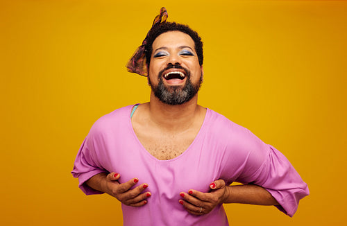 Drag queen posing on yellow background
