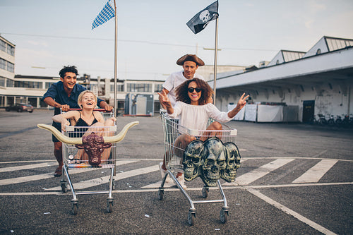 Friends racing with shopping cart