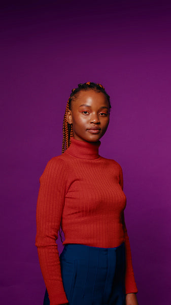 Confident young woman poses for a studio portrait