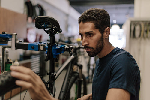 Mechanic repairing a bicycle in workshop