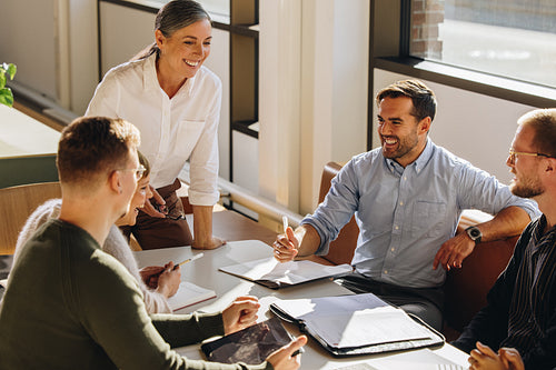 Smiling female executive talking in meeting