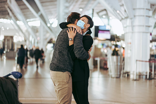 Woman welcoming and embracing her boyfriend at airport