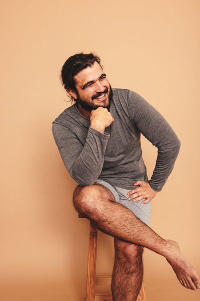 Happy young man smiling cheerfully in a studio