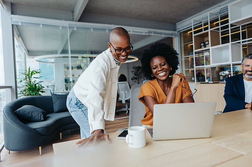 Successful businesswomen collaborating and working with technology in a vibrant office environment
