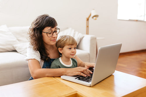 Mother and son using laptop