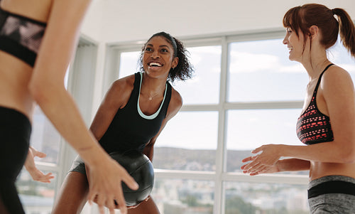 Smiling workout partners exercising with medicine ball