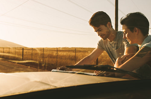 Couple on a road trip looking at map for navigation