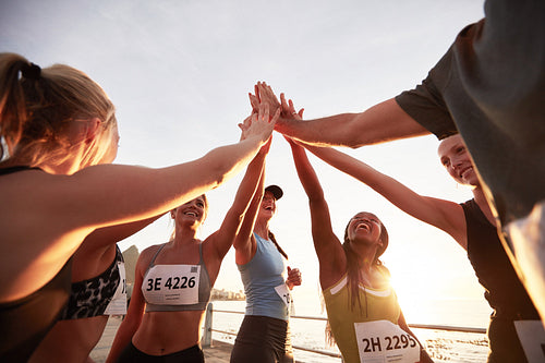 Runners high fiving each other after a good training session