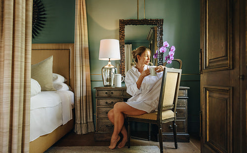 Young woman having coffee during a luxury vacation