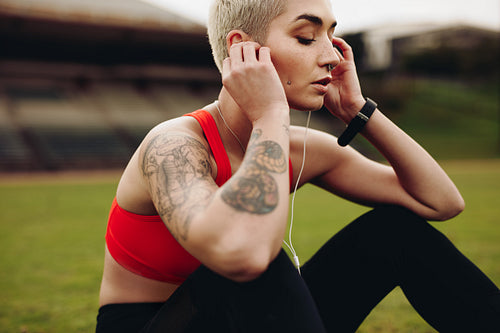 Close up of a female athlete relaxing listening to music