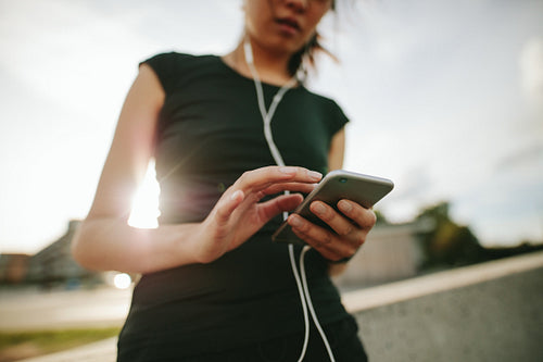 Sporty woman taking a break after running outdoors