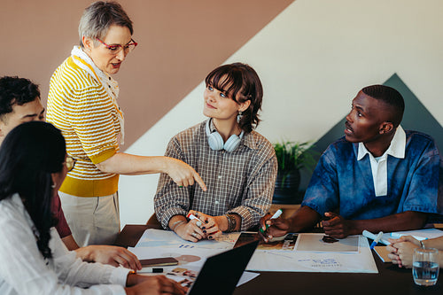 Modern classroom setting with diverse group and inspiring teacher engaging in active discussion and collaboration