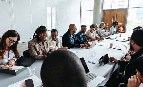 Diverse group of people in a business meeting having a discussion in a modern office