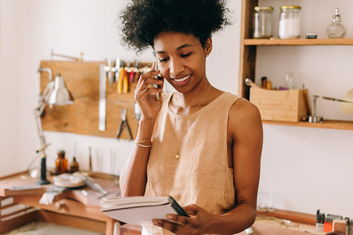 Ornament designer doing business using phone