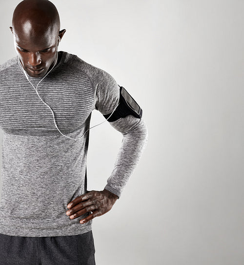 Young man wearing earphones to listen music