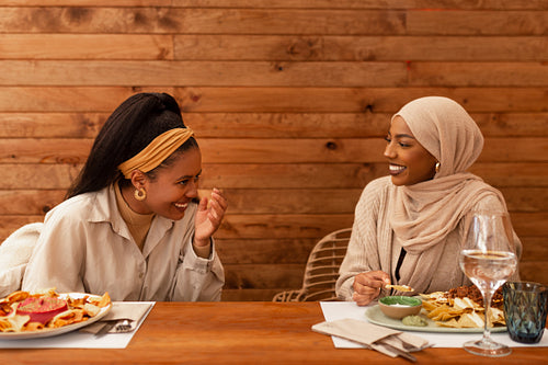 Best friends laughing cheerfully in a restaurant