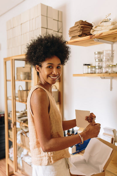E-commerce business owner packing handmade jewelry