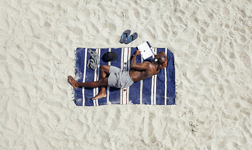 Young guy relaxing on beach