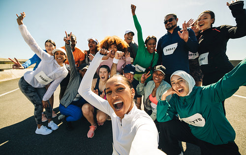 Group of friends taking a selfie at pre-race gathering