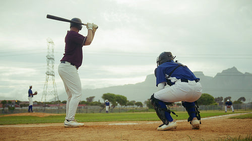 Baseball game: batter hits a pitch on the field