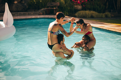 Friends having fun in the holiday resort pool