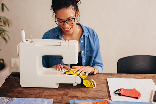Woman sewing protective face masks at home