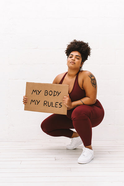 Attractive woman with "My body my rules" banner
