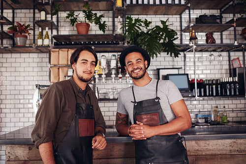 Two young coffee shop owners at the counter