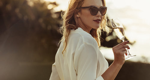Attractive woman drinking wine outdoors