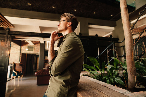 Handsome young man making a phone call