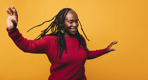Happy black woman having fun in a studio