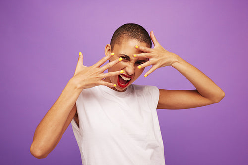 Excited female model showing her vivid makeup