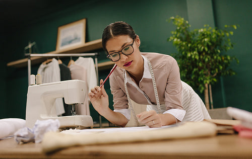 Young woman working in fashion studio