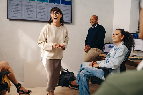Cheerful coworkers chatting during a project meeting in a modern office space