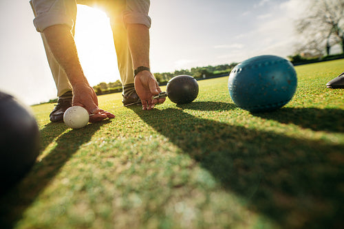 Man measuring the distance between boules