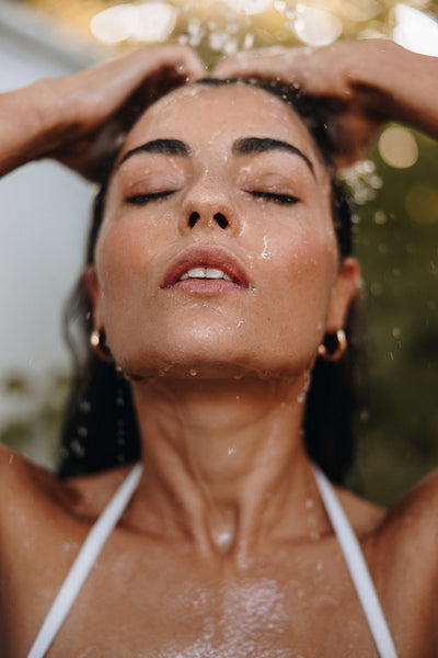 Closeup of a woman showering outdoors