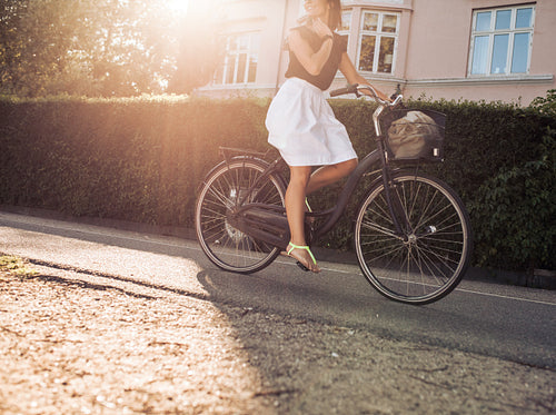 Woman riding bicycle along the street
