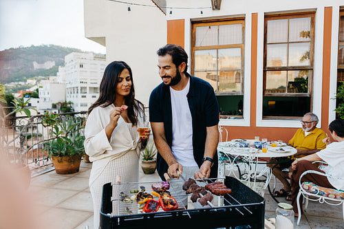 Family enjoying a traditional Brazilian churrasco on a sunny terrace