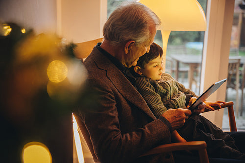 Grandfather and grandson video calling during a pandemic on Christmas eve