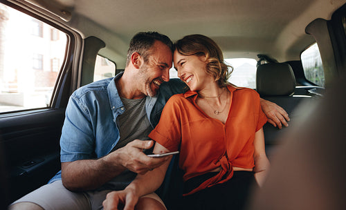 Couple in love traveling by a taxi