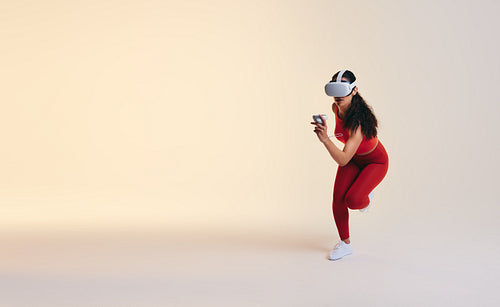 Fit young woman working out in virtual reality
