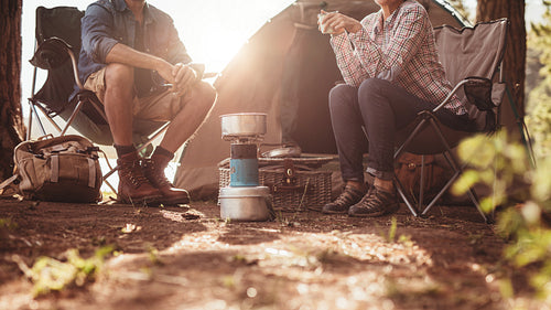 Couple sitting in chairs outside the tent