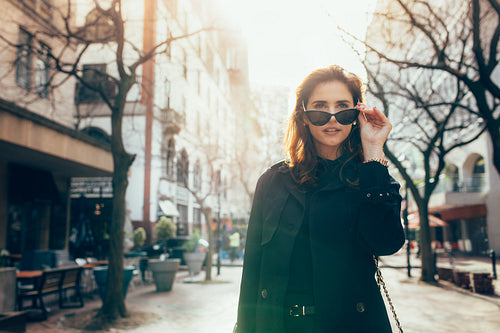 Attractive young woman walking down the street