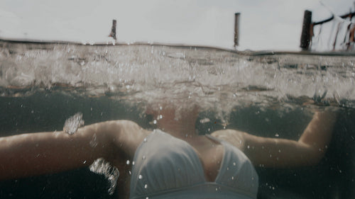 Woman submerged in a cold plunge ice bath outdoors